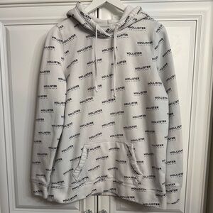 Hollister Men’s Size Medium White Hoodie w/Black Logo Print All Over Pattern